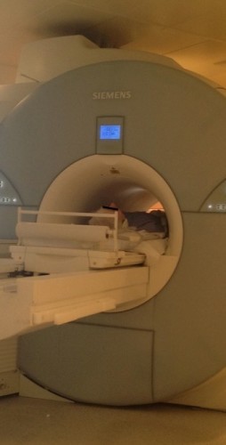 A photo of the scanner during an examination. Note how tight a squeeze it is for the patient - it's not surprising that claustrophobia is a significant problem.